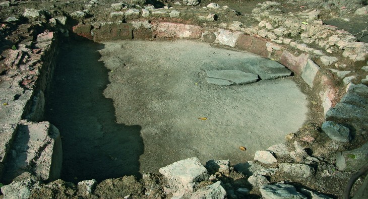 Freigelegte Mauerreste in einem halbrunden Becken